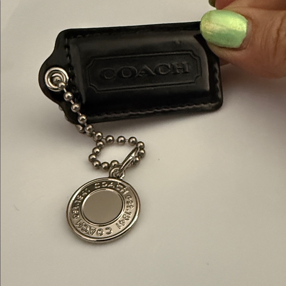 Coach Black Leather Key Holder Silver medallion Hang tag bag charm. 3.5 by 1.25